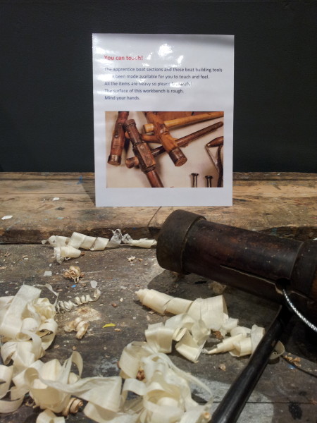Tactile work bench with boat building tools and apprentice pieces from Falmouth Marine School.