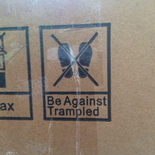 Cardboard box with sign saying Be Against Trampled.
